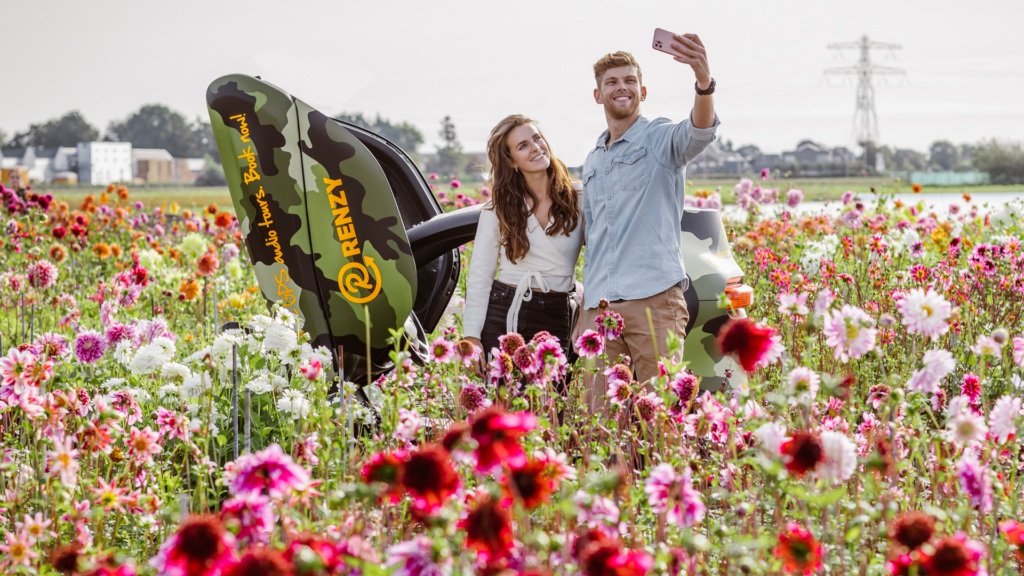 couple-taking-a-selfie-in-flower-fields-on-date-with-Renzy-tours