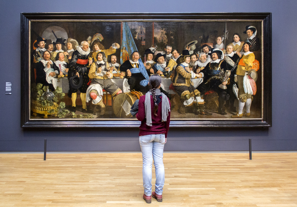girl-looking-at-big-painting-in-a-museum