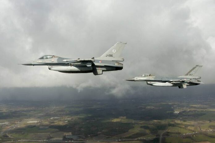 two-dutch-f-16-planes-flying-through-air-withgrey-thunderclouds-following-russian-bomber-plane