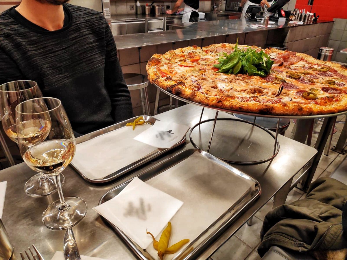 Serving-of-full-sized-pizza-at-a-table-in-toni-locos-restaurant-in-amsterdam-the-netherlands