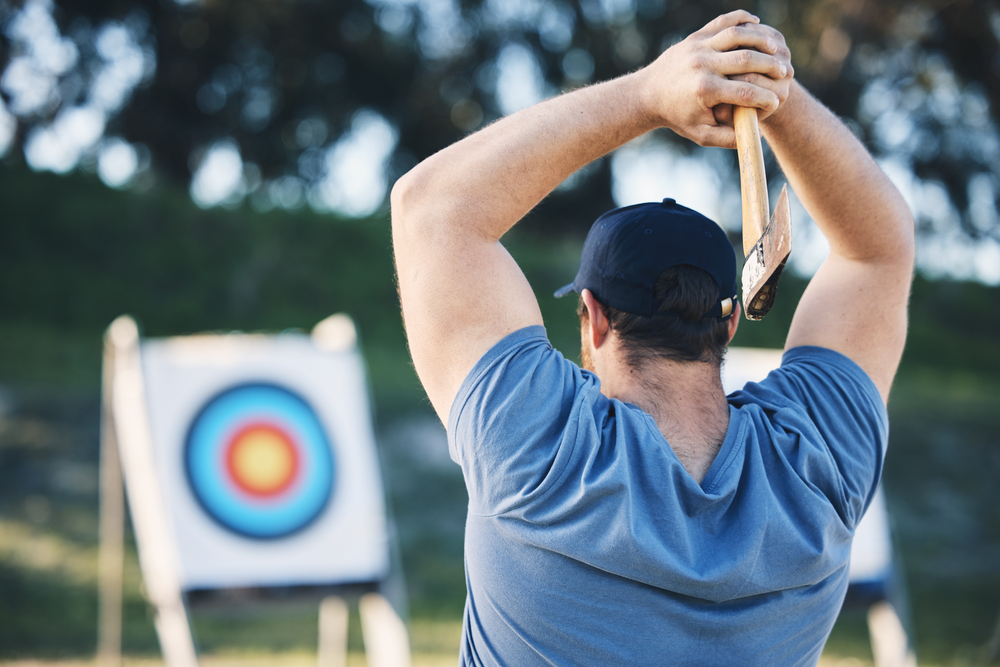 Man-axe-throwing-at-sports–range–archery–training–or-practice–with-board–circle–for-action-game-and-fitness