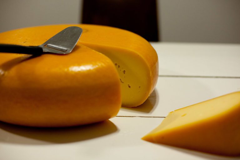 A-big-wheel-of-Dutch-cheese-with-a-cheese-slice-on-top