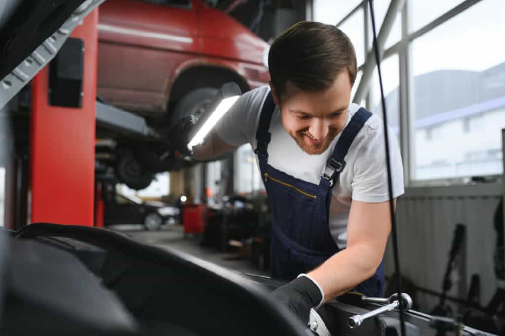 photo-of-mechanic-carrying-out-APK-Motor-Vehicle-Test-in-the-Netherlands-looking-under-hood