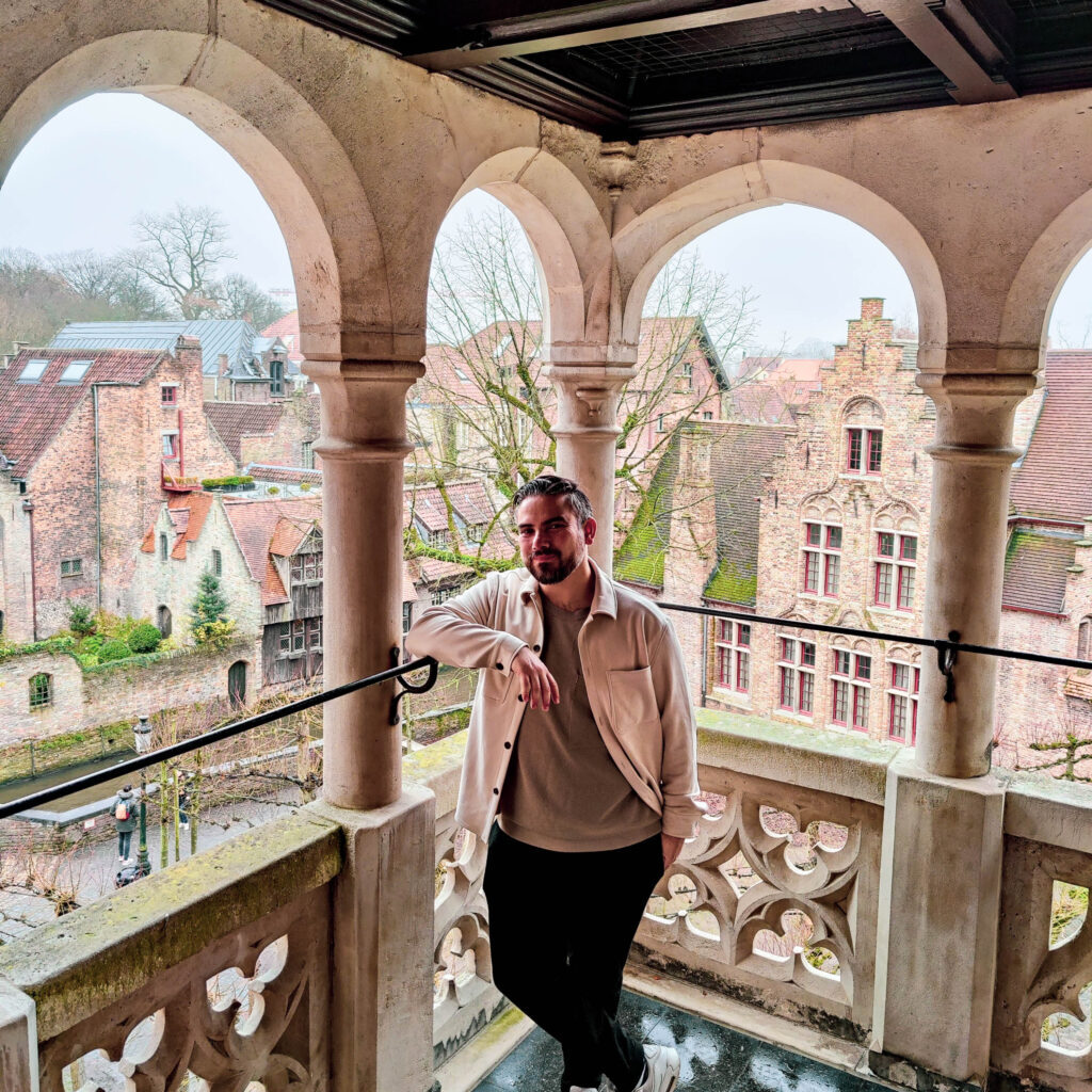 photo of man on a balcony during winter trip to bruges 