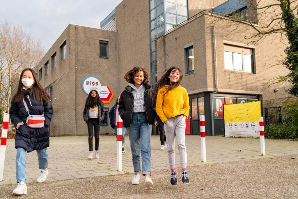 Photo-of-students-of-Rotterdam-International-Secondary-school-walking-outside-school-building