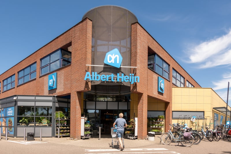 Albert-Heijn-storefront-with-dutch-man-leaving-store-that-is-far-away-from-his-flex-home