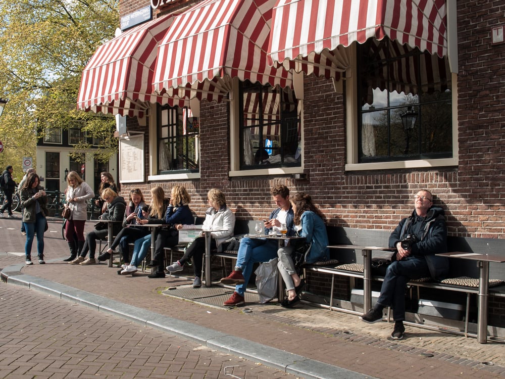 people-enjoying-sunny-weather-in-amsterdam-waiting-customer-service