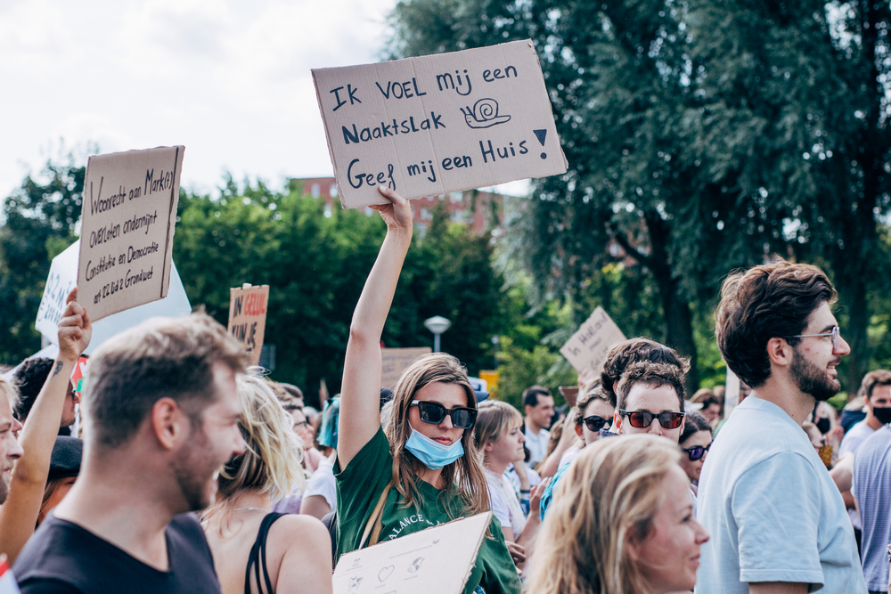 picture-of-a-person-holding-a-sign-at-housing-protest-Amsterdam