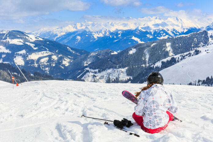 Photo-of-woman-sitting-in-snow-on-Austrian-alps