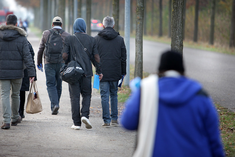 Asylum-seekers-walking-on-street-with-trees-in-the-Netherlands