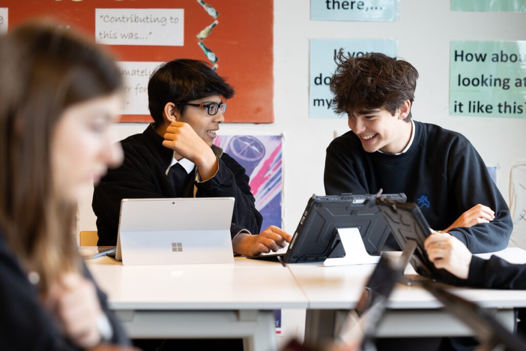 Two-students-using-laptops-and-tablets-to-learn-in-class-at-the-British-school-in-the-netherlands