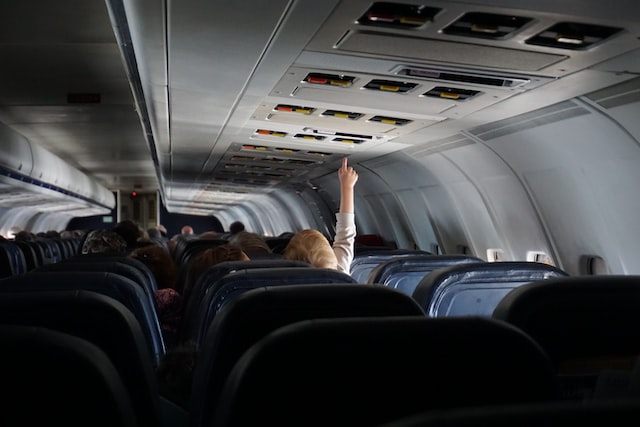 baby-reaching-hand-up-on-plane