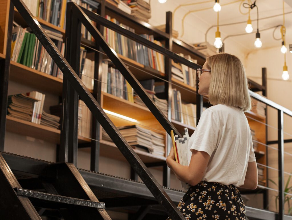 Woman-walking-up-stairs-towards-book-shelf