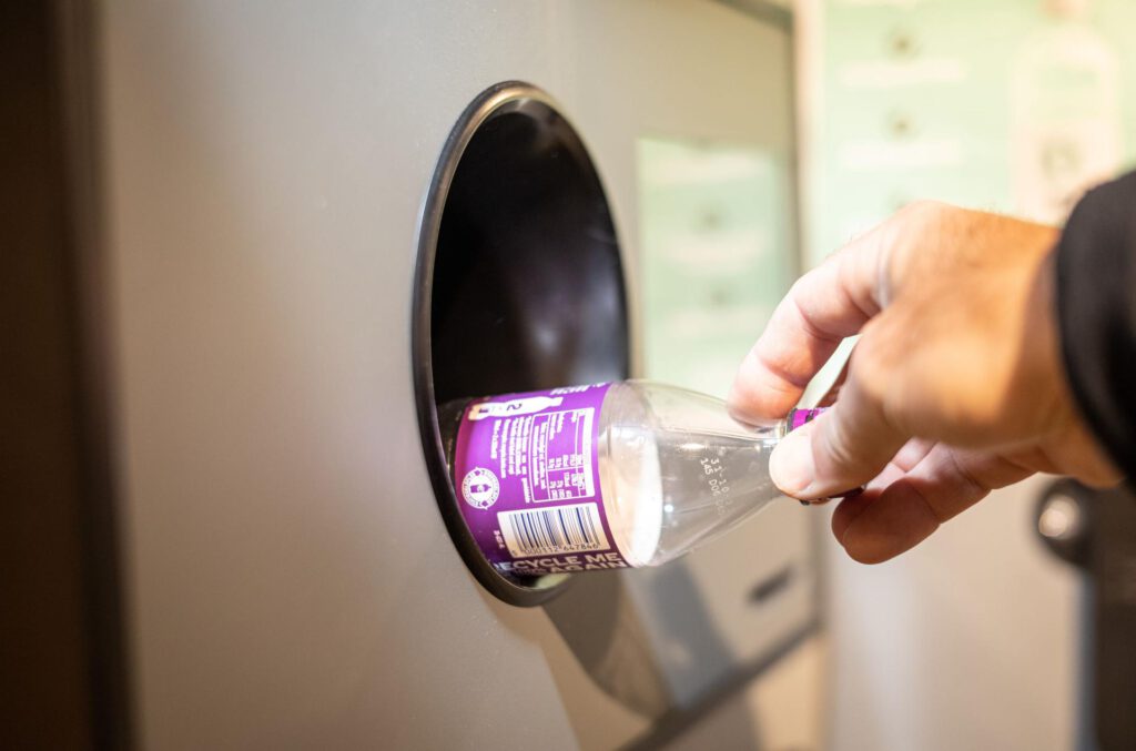 Person-drops-off-plastic-bottle-at-drop-off-point-in-a-dutch-supermarket