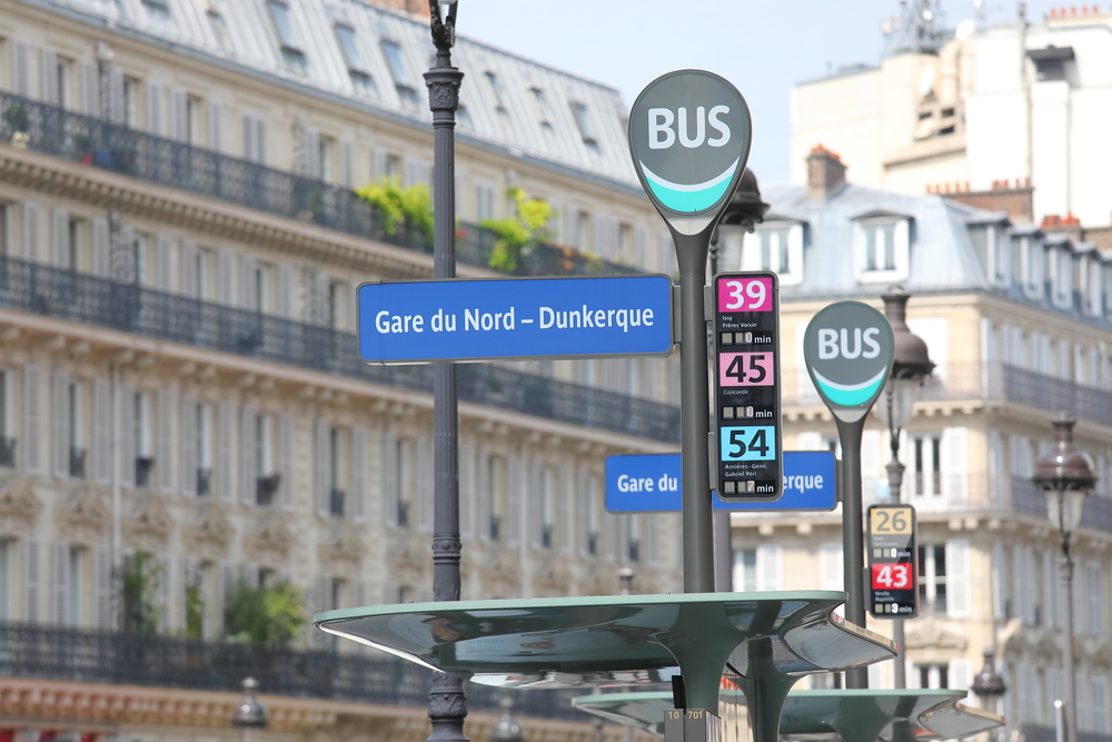 Blue-bus-stop-signs-and-Paris-buildings