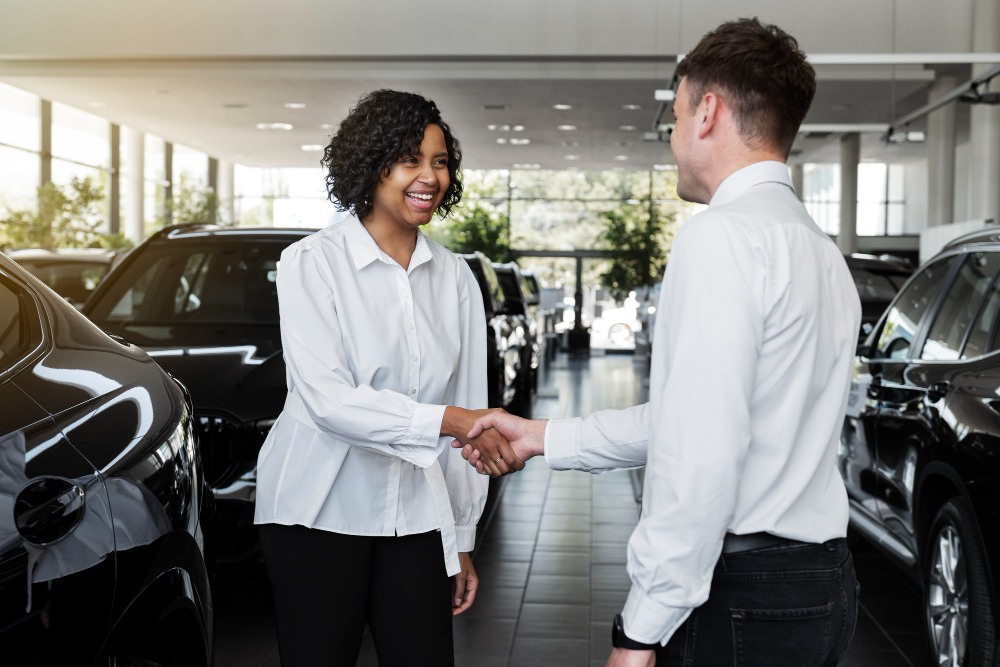 photo-of-two-people-shaking-hands-at-car-dealership