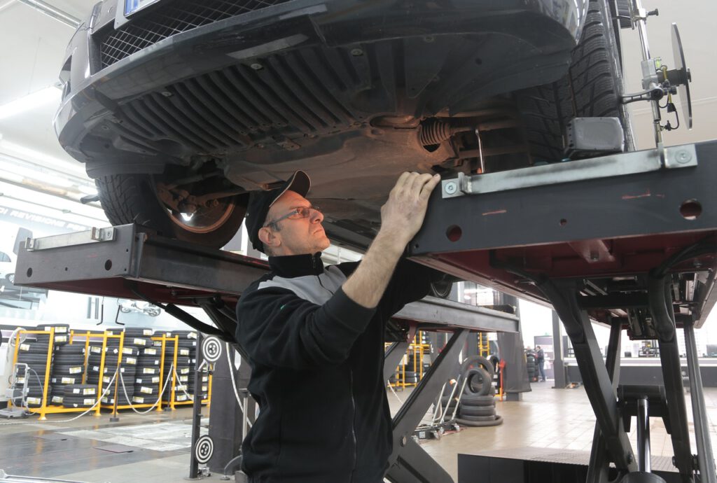 Mechanic-inspecting-the-underide-of-a-car