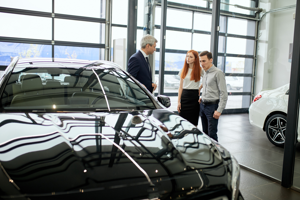 Car-sales-manager-helping-customers-buy-a-car-in-the-Netherlands