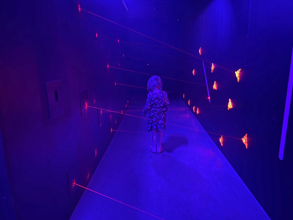 Kid-dodging-lasers-at-daytrip-LEGOLAND-Discovery-Centre-The-Hague