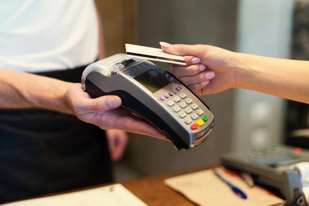 photo-of-person-paying-with-card-on-machine