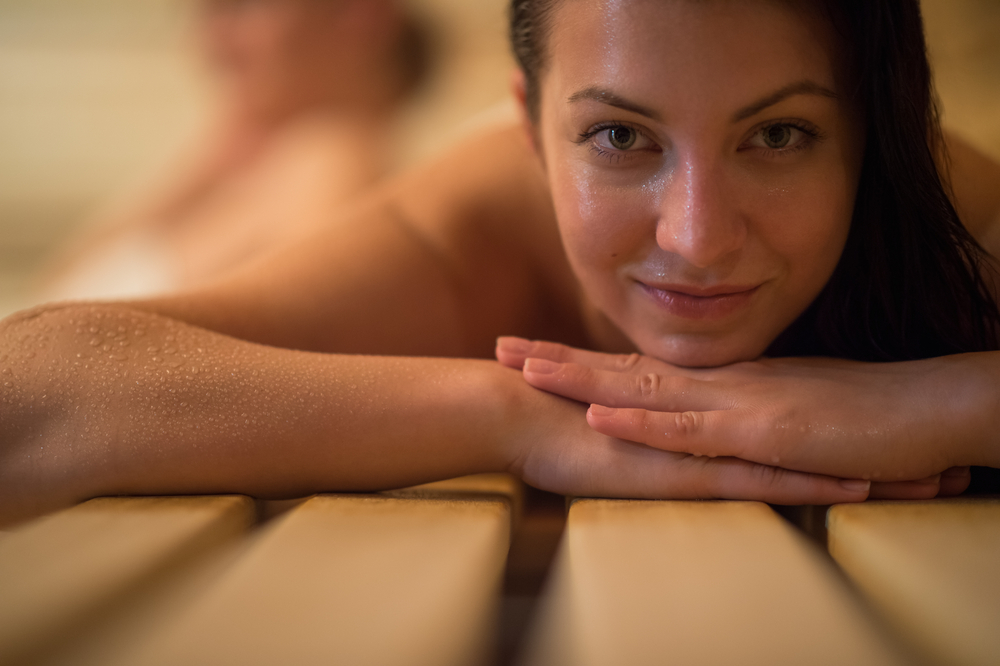 Close-up-of-woman-resting-her-chin-on-arms-in-Dutch-sauna-in-the-netherlands