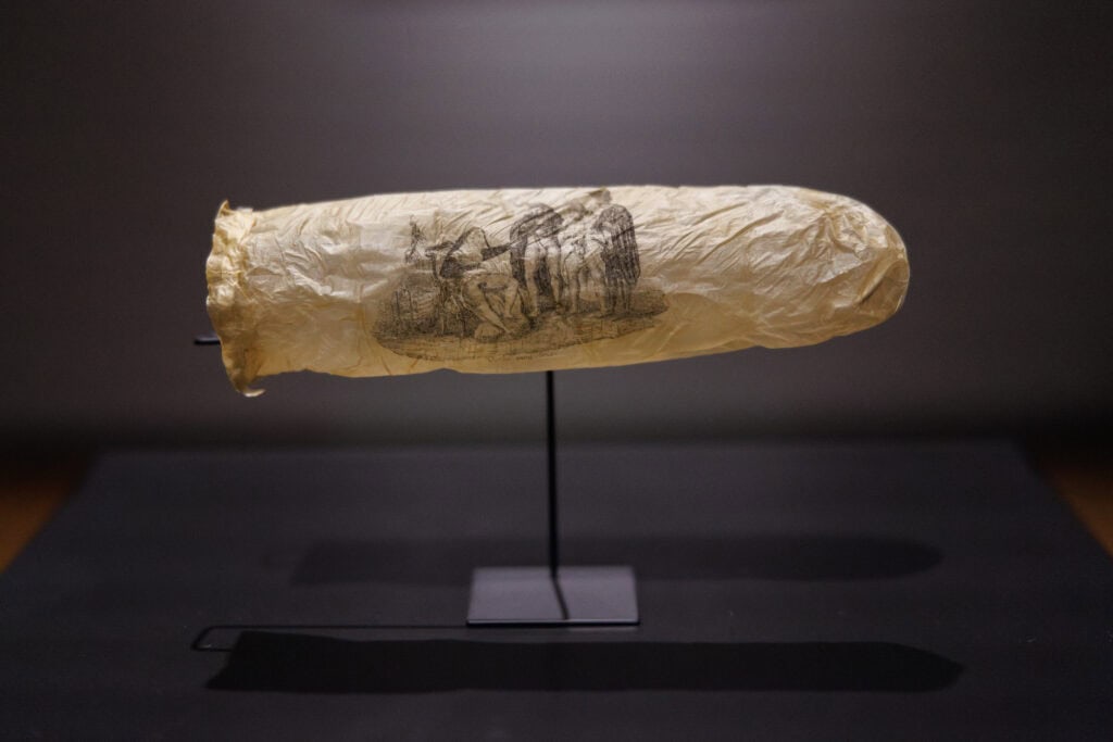photo-of-historical-condom-with-print-on-it-on-black-background