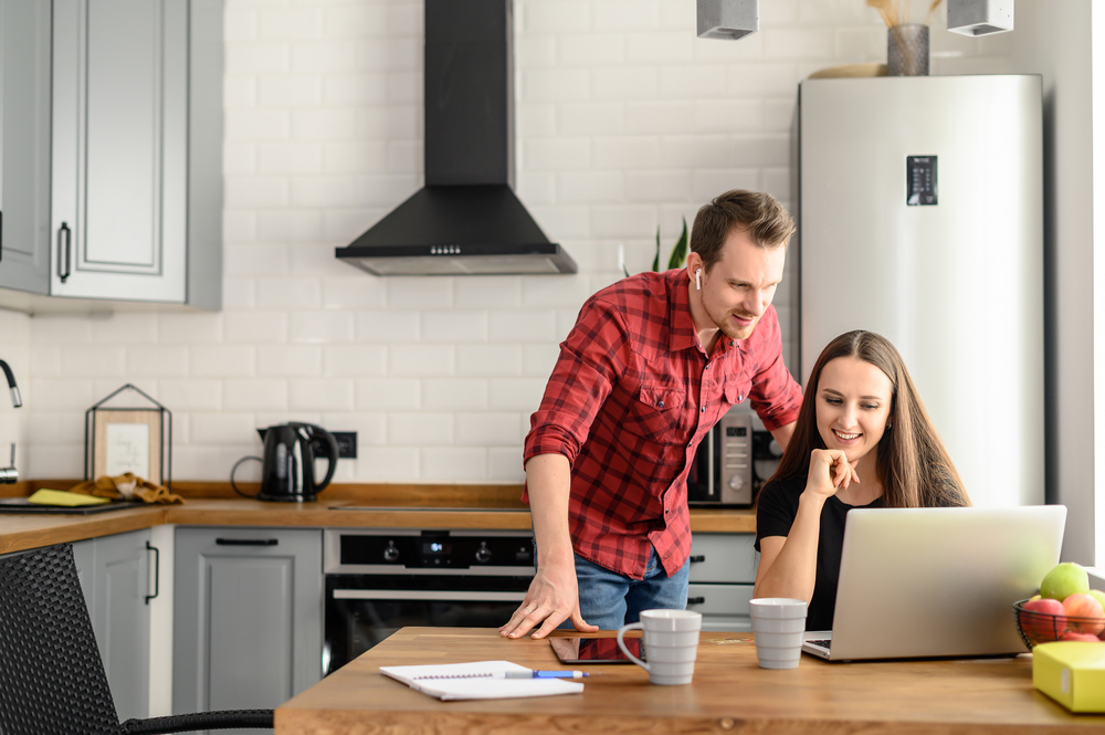 Photo-of-couple-in-kitchen-looking-at-laptop