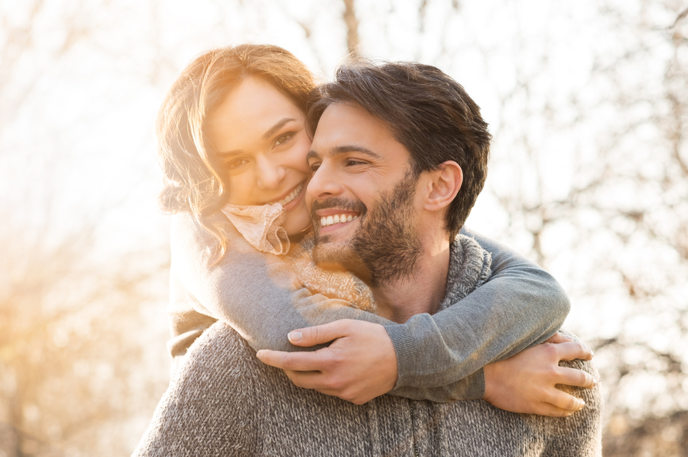 Pretty-woman-hugging-attractive-man-lovingly-from-behind-after-he-used-dutch-pick-up-lines-on-her