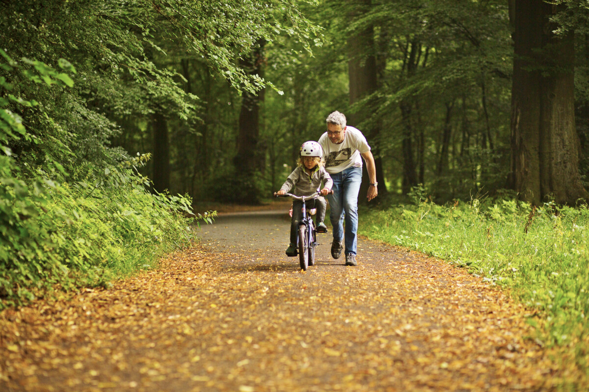 Photo-of-child-on-bike-with-parent