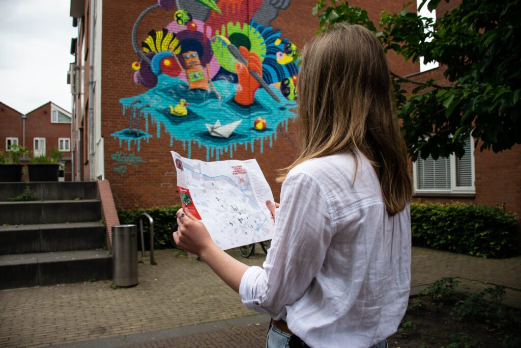 photo-of-a-girl-looking-at-a-map-of-street-art-in-tilburg