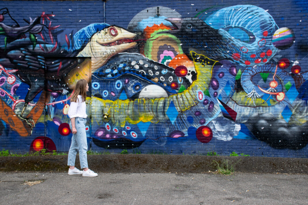 girl-standing-in-front-of-creative-graffiti