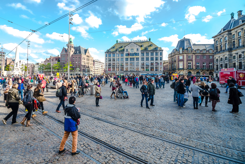 people-walking-around-on-dam-square-amsterdam-on-a-sunny-day