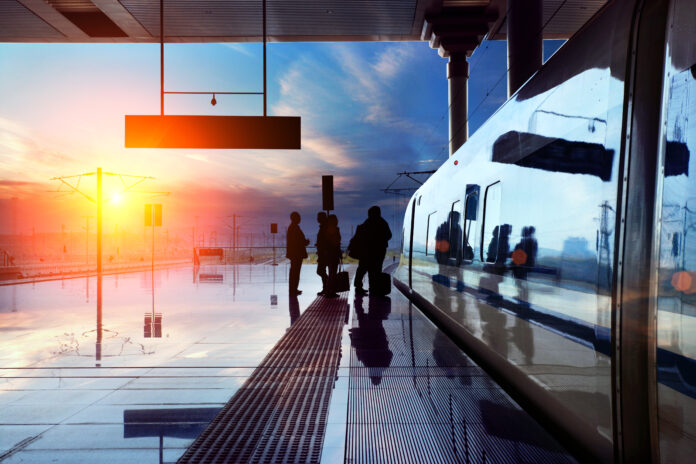Photo-of-people-boarding-or-leaving-a-train-during-sunrise-in-the-early-morning