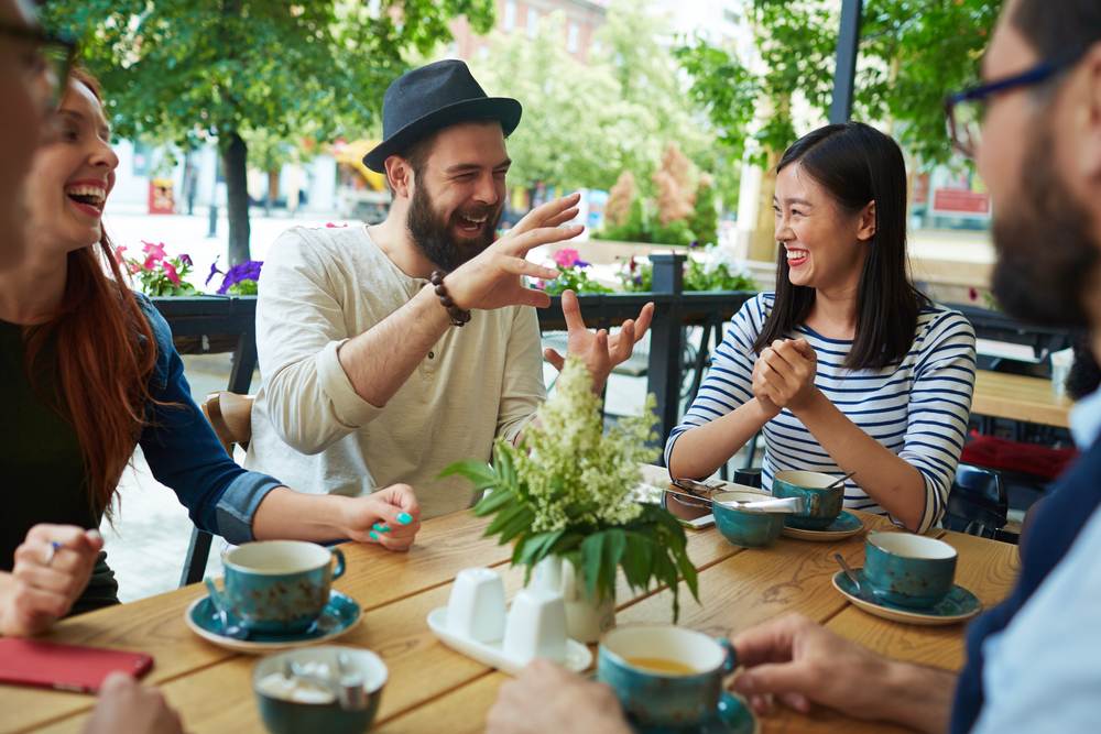 a-group-of-dutch-people-talking-and-laughing-at-a-cafe