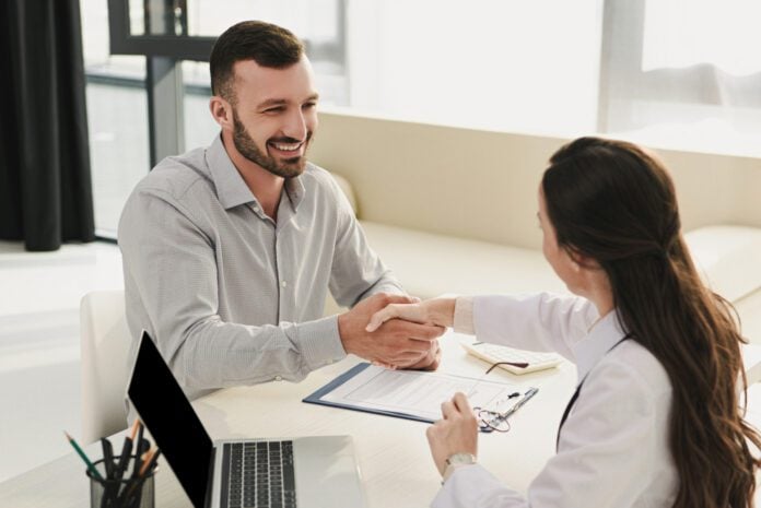 man-and-woman-shaking-hands-in-the-doctors-office