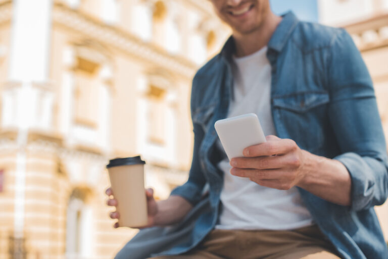 Photo-of-man-using-Raisin-savings-account-on-phone-Netherlands