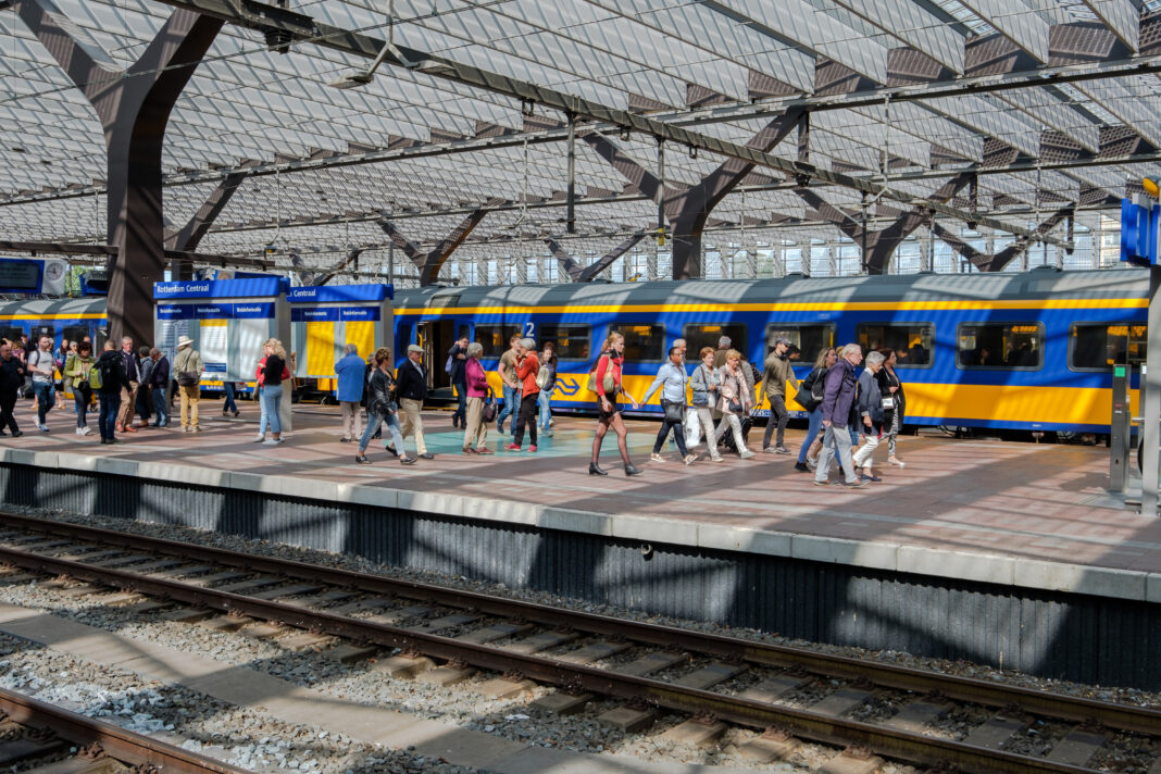 Passengers-in-Rotterdam-train-station-waiting-and-rushing-to-catch-a-train