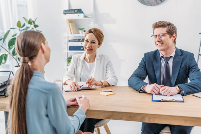 Photo-of-woman-sitting-in-chair-in-front-of-table-with-interviewers-at-job-interview-in-the-Netherlands