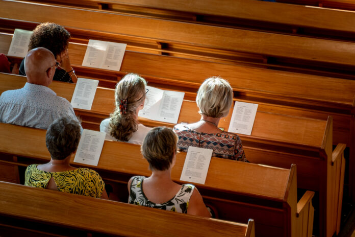 View-of-Dutch-Christians-sitting-in-church-singing-worship