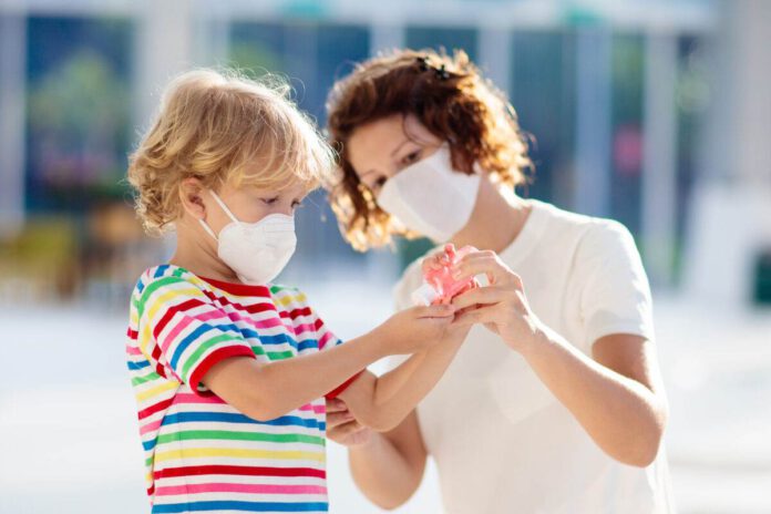 photo-of-a-mom-with-a-child-wearing-face-masks