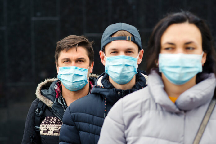 Group-of-three-Dutch-people-wearing-coronavirus-masks-outside