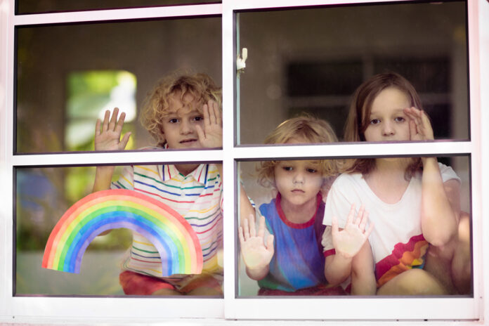 Three-Dutch-school-children-staring-out-of-a-window