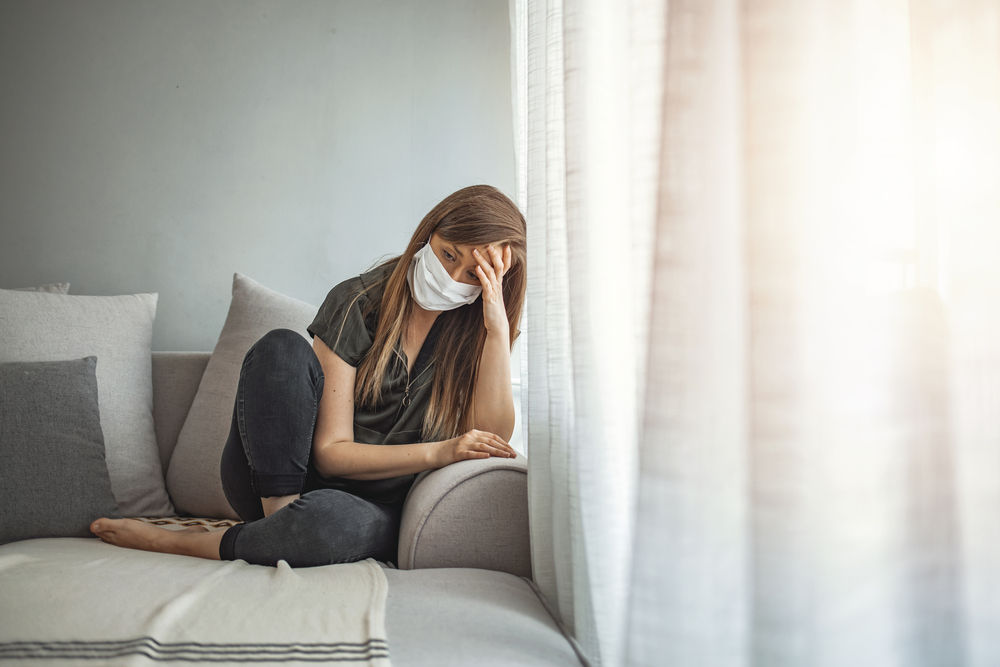 Sad-Dutch-student-sitting-on-a-sofa-head-in-hand