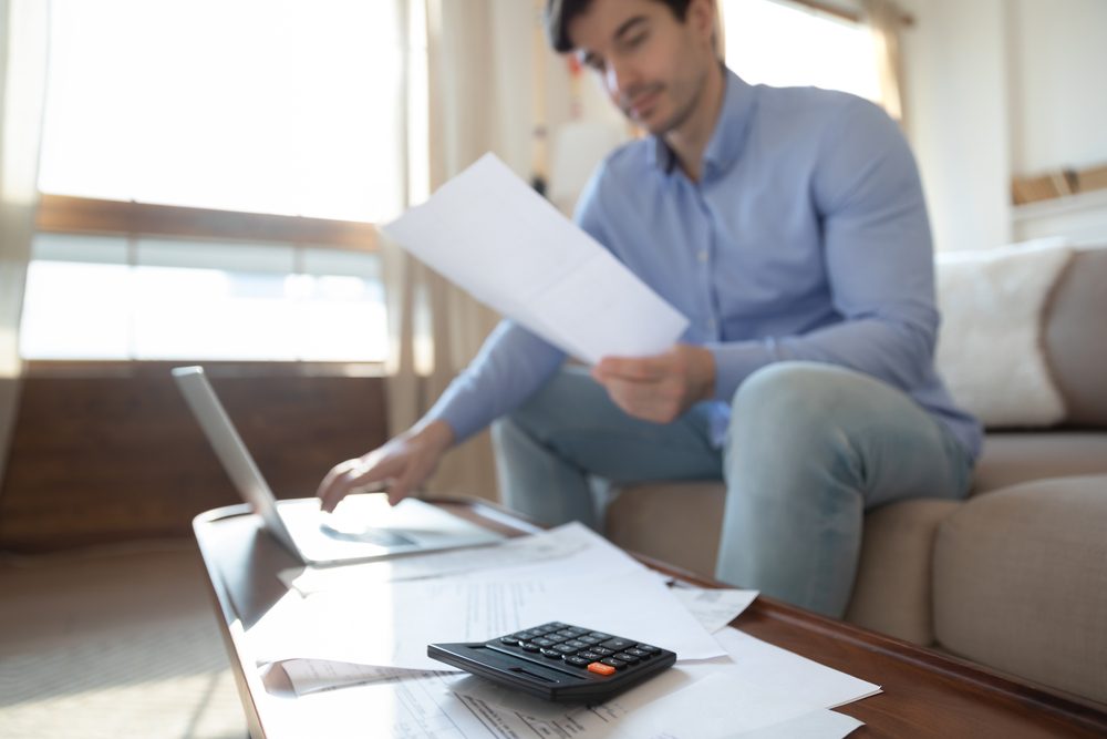 photo-of-a-young-man-going-through-his-utility-bill