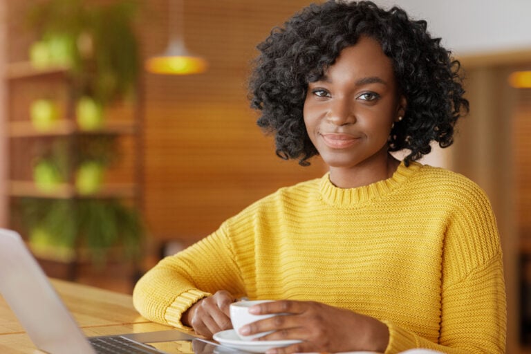 Photo-of-expat-worker-smiling-on-laptop