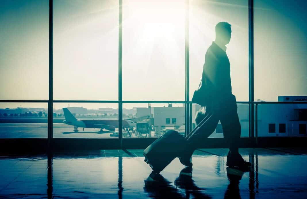 picture-of-man-at-the-airport-carring-a-suitcare