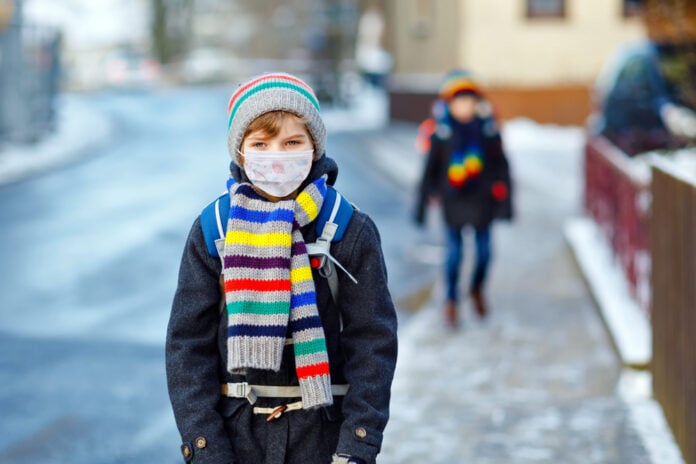 small-boy-wearing-scarf-gloves-and-winter-hat-with-mask