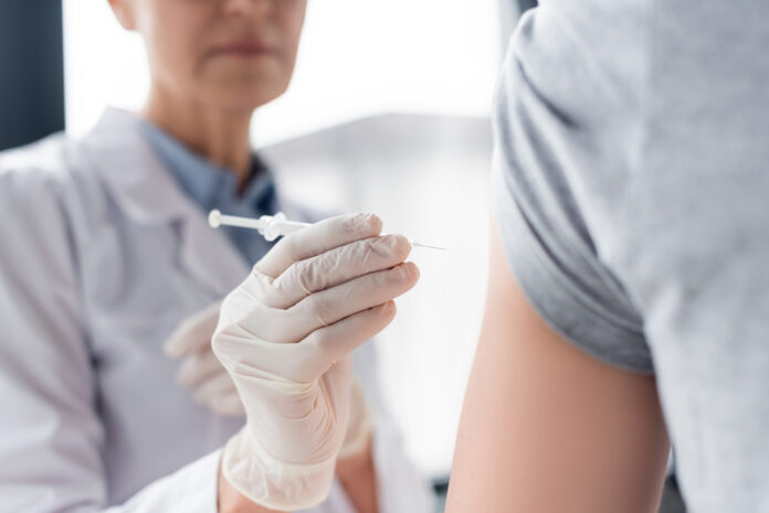 Cropped-view-of-Dutch-doctor-giving-coronavirus-vaccine-to-patient