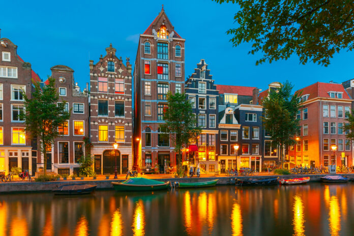 photo-of-amsterdam-canal-houses-at-night