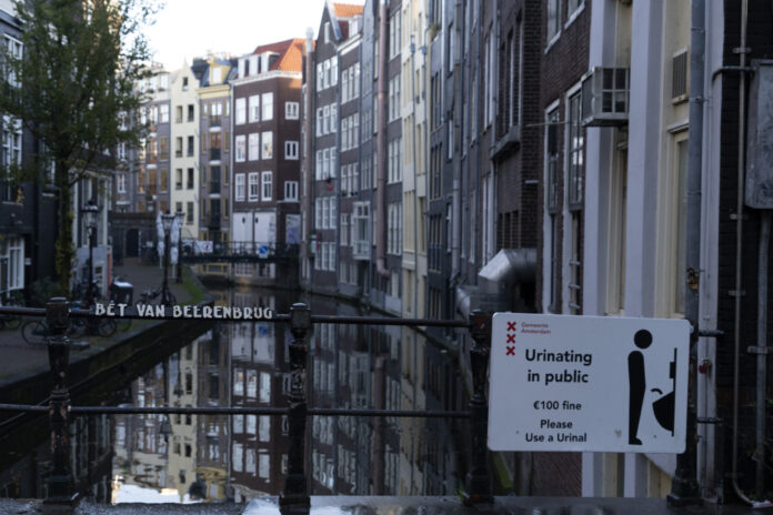 no urinating in the street sign in Amsterdam canal view
